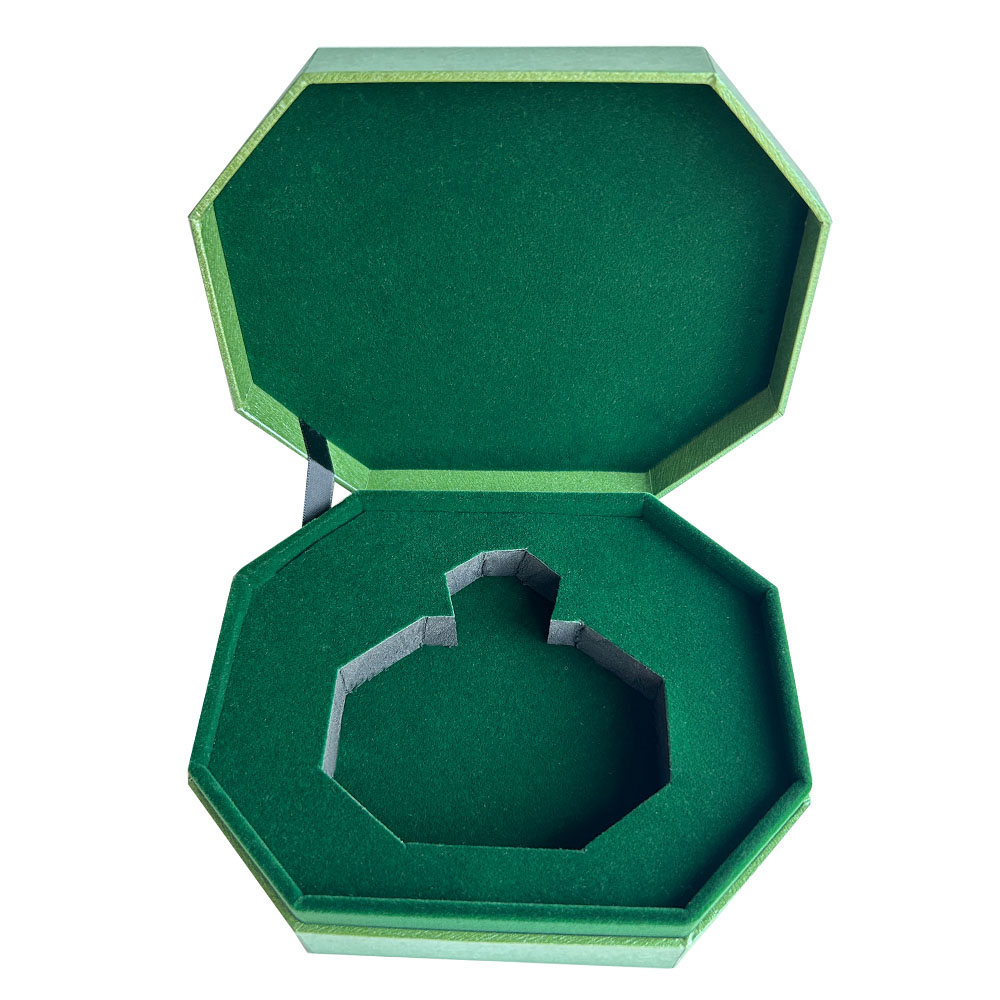 Open perfume gift box with green flocked bottle insert